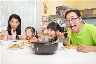 Happy asian Family Eating noodles