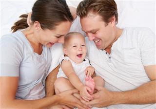 Portrait of a young family laughing together