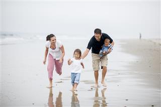 Family Running on the Beach
