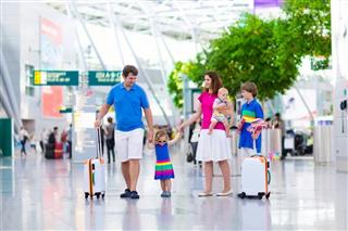 Happy family with kids at airport