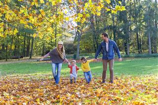 Family walking on leaves