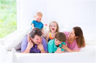 Cute happy big family in a bed