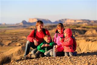 Family with two kids hiking in mountains