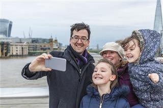 Young Family Taking Vacation Selfie Photo in London as Tourists