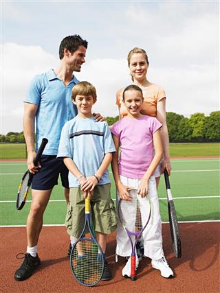 Family on tennis court