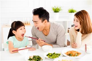 Happy asian young Family enjoy their lunch