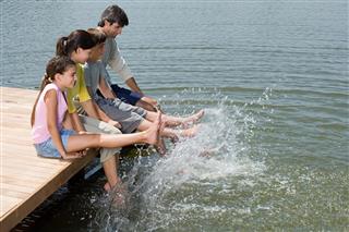 Family splashing feet in lake