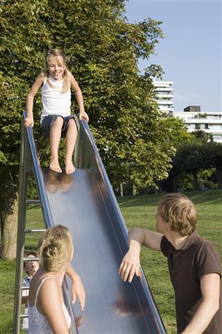 Family playing on slide