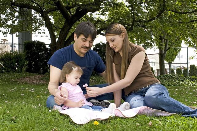 Caucasian Young Family at the Park with Baby Girl