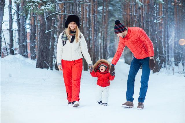 Young family with child on the winter background