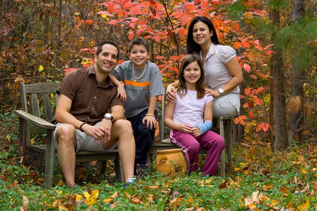 Family Posing In Fall Garden