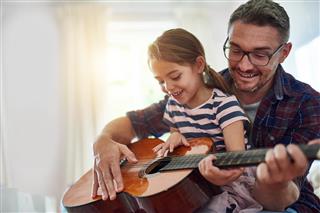 Father and Daughter Playing Guitar