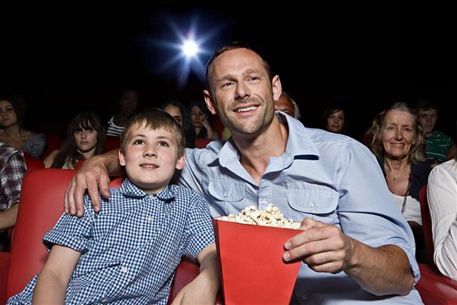 Father and Son Enjoying Movie