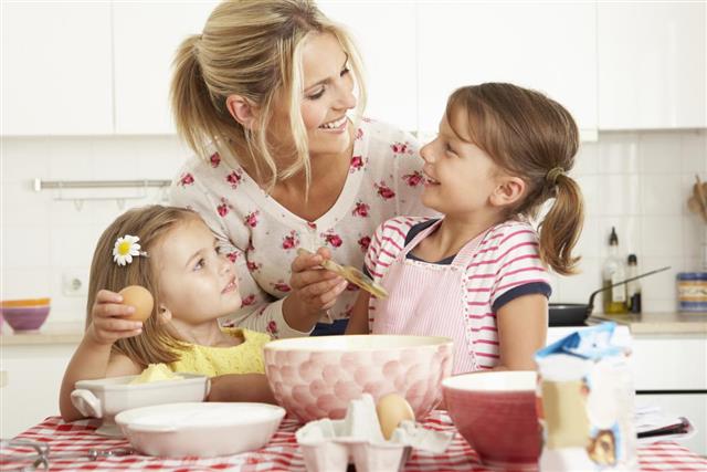 Mother and Two Girls Baking Cake
