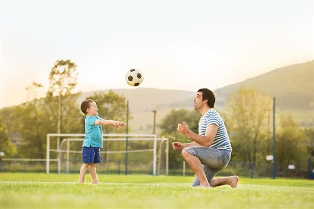 Father and Son Playing Football