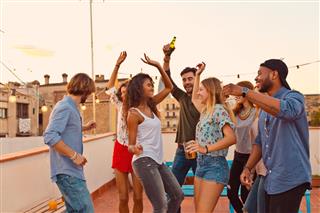 Friends Dancing At Rooftop Party