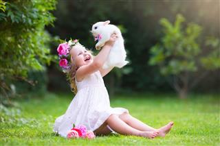Little Girl Playing With Real Rabbit