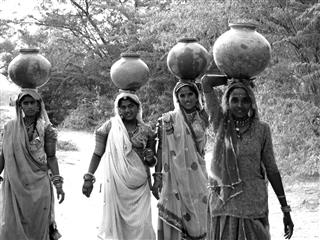 Women Bringing Water To Village