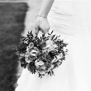 Bride Holds Wedding Bouquet Of Flowers