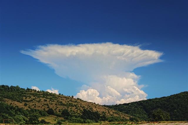 Anvil Storm Cloud And Blue Sky With Hills