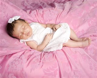 Precious Sleeping Newborn Baby On Pink Background