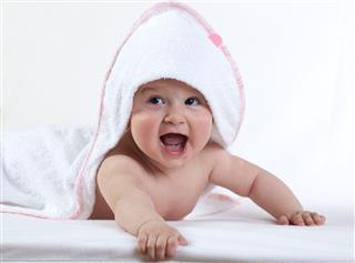 Happy Baby In White Towel