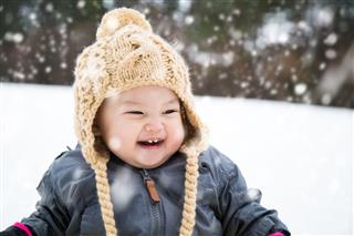 Baby Playing Outside In The Snow