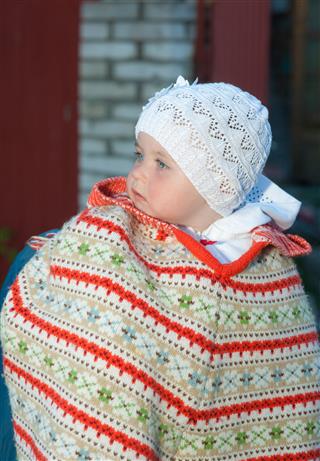 Baby In Cap And Poncho