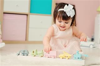 Baby Girl Playing With Wooden Toys