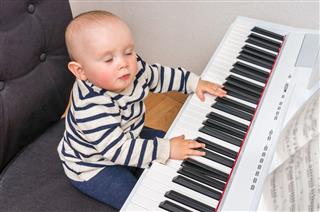 Cute Little Baby Plays Piano