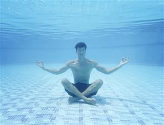 Man Sitting In Yoga Pose Underwater