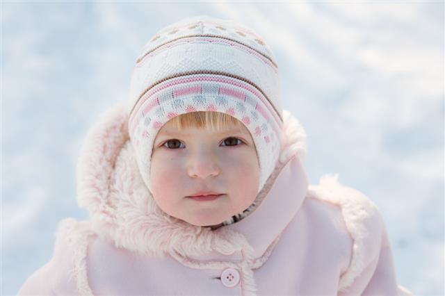 Little Girl Outdoors In Winter Clothing