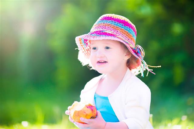 Funny Girl In A Hat Eating Apple