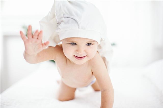 Playful Baby On A Bed