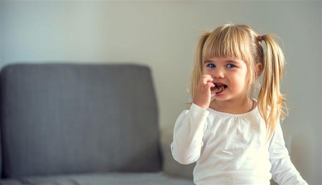 Cute Little Girl Eating Chocolate