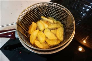 French Fries Cooking In Deep Fryer On Electric Stove