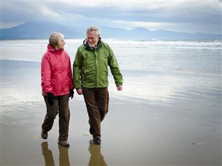 Happy Retired Couple On Beach