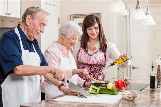 Woman Help Elderly Couple Cook