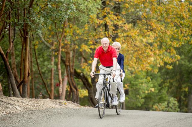 Senior Couple Riding A Tandem Bike