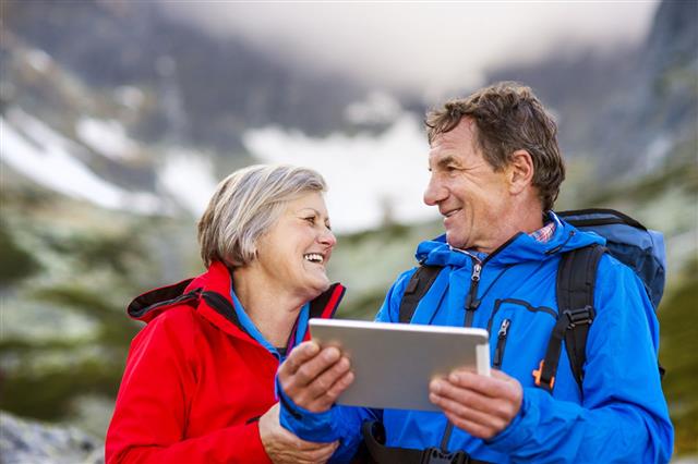 Senior Hikers Couple With Tablet