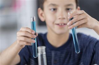 Schoolboy Works On Chemistry Experiment