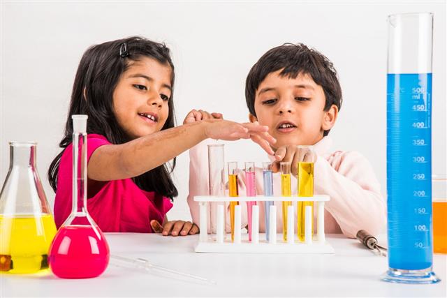 Girl And Boy Doing Science Experiment
