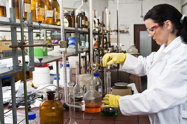 Scientist In Lab Coat Working With Chemicals