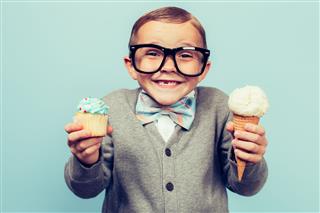 Boy Holds Ice Cream And Cupcakes