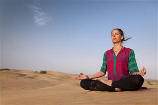 Young female practicing yoga meditation