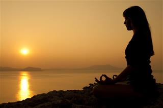 Yoga lotus position at sunrise