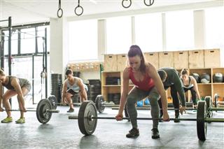 Group of people lifting weights at fitness class