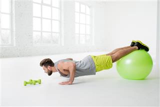Man exercising with fitness ball