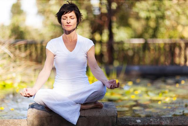 Middle aged woman doing yoga meditation