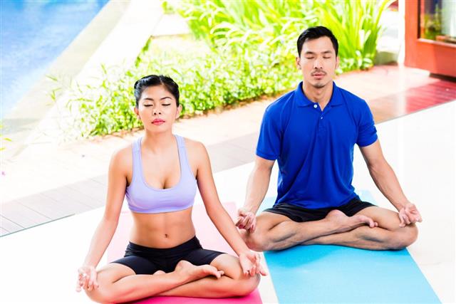 Asian yoga couple in lotus seat mediating